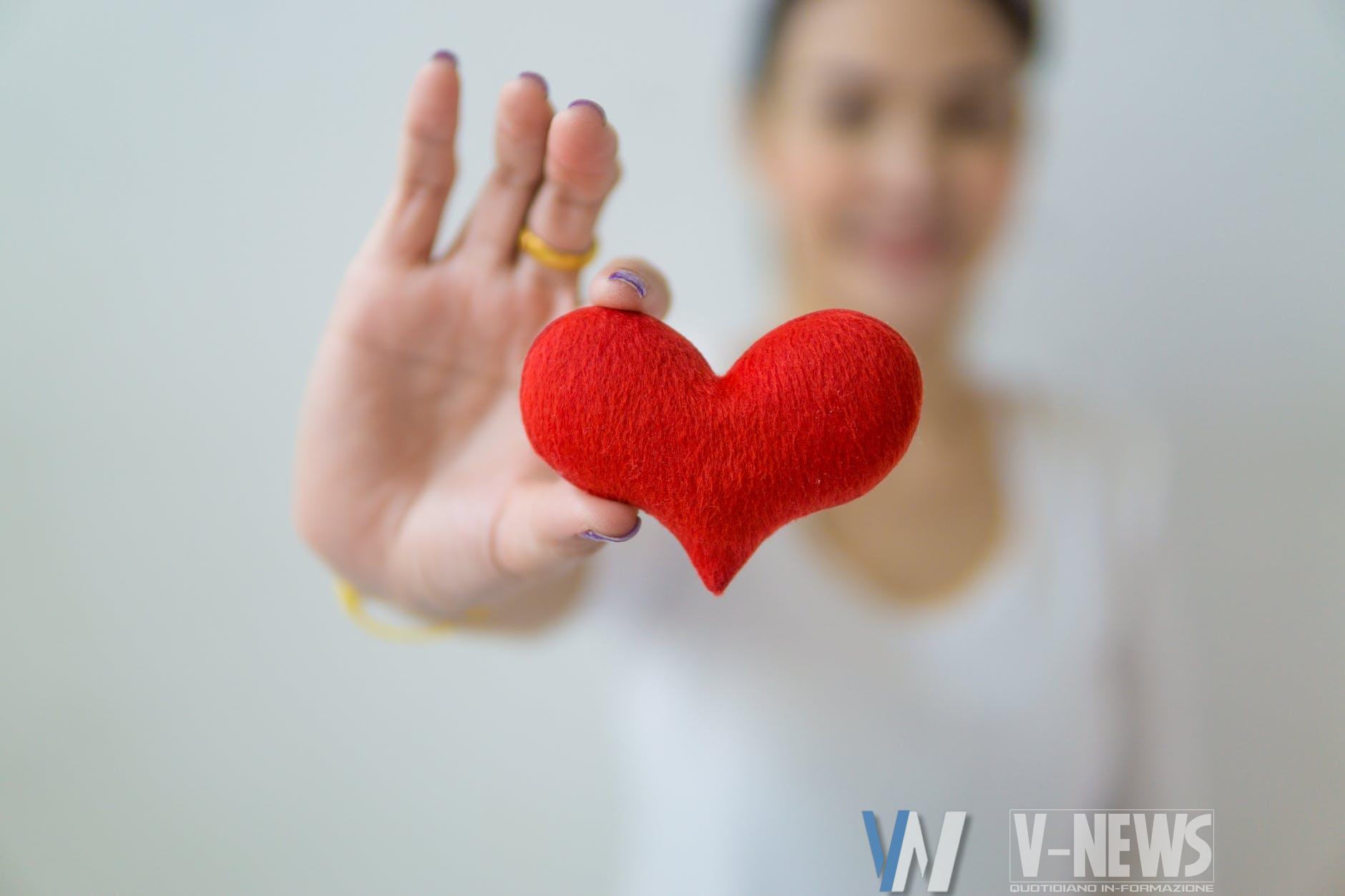 anonymous woman showing small heart