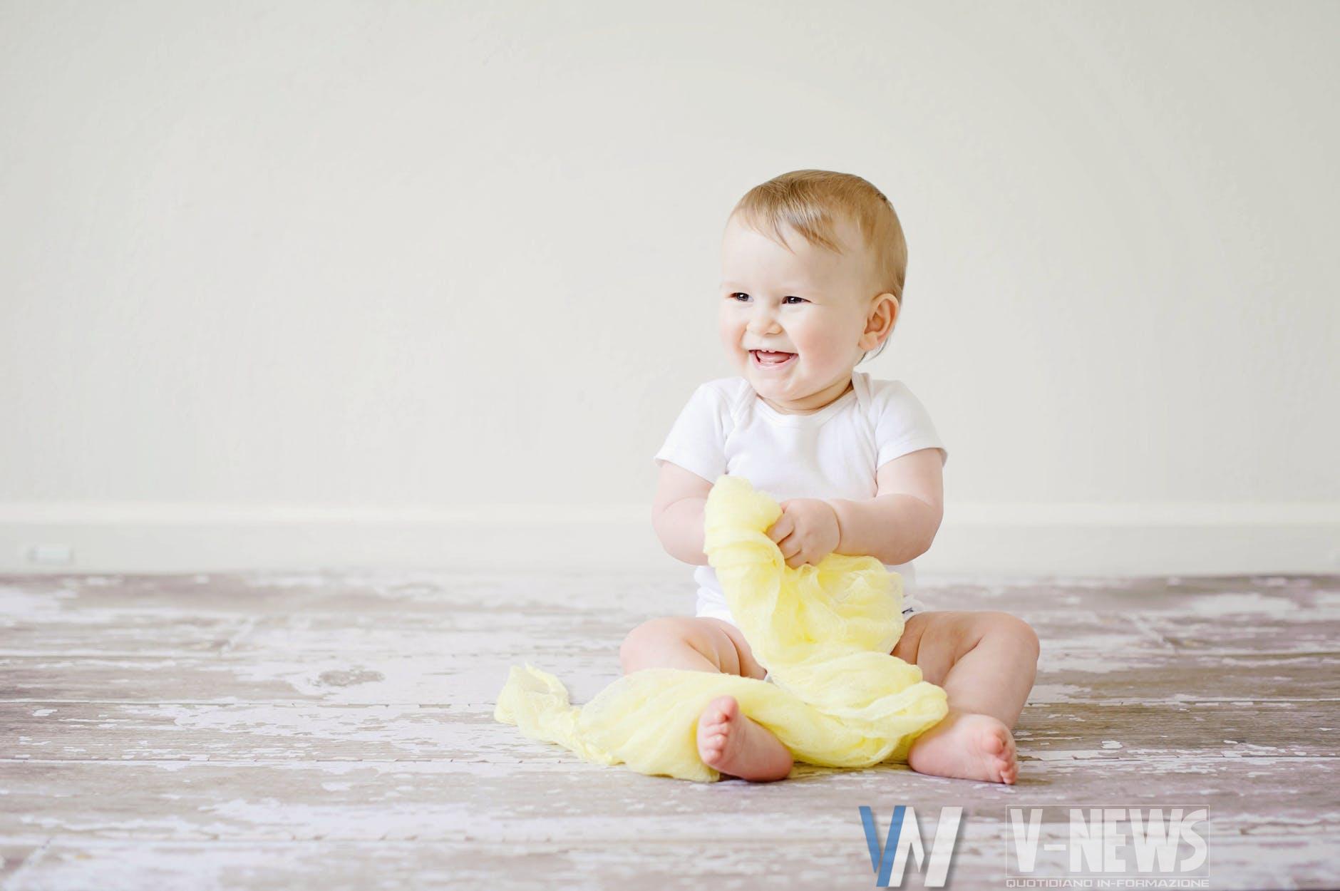 toddler sitting while smiling